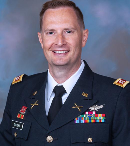 Alan Duggar smiling in his military dress clothes