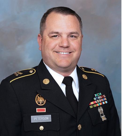 Jesse peterson smiling at the camera, wearing his military dress clothes