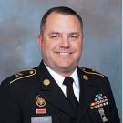 Jesse peterson smiling at the camera, wearing his military dress clothes